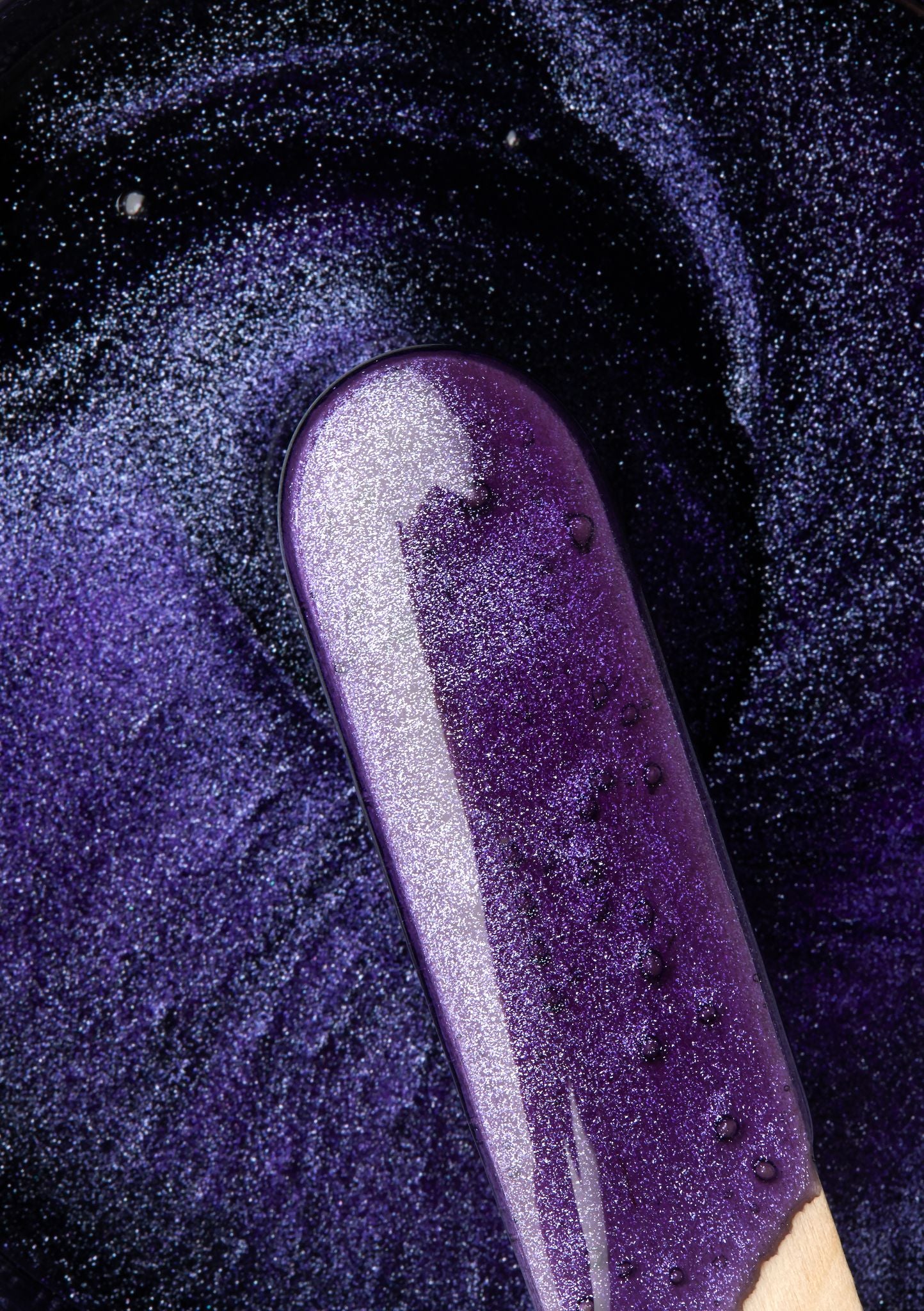 bikini waxing spatula in sparkling purple wax